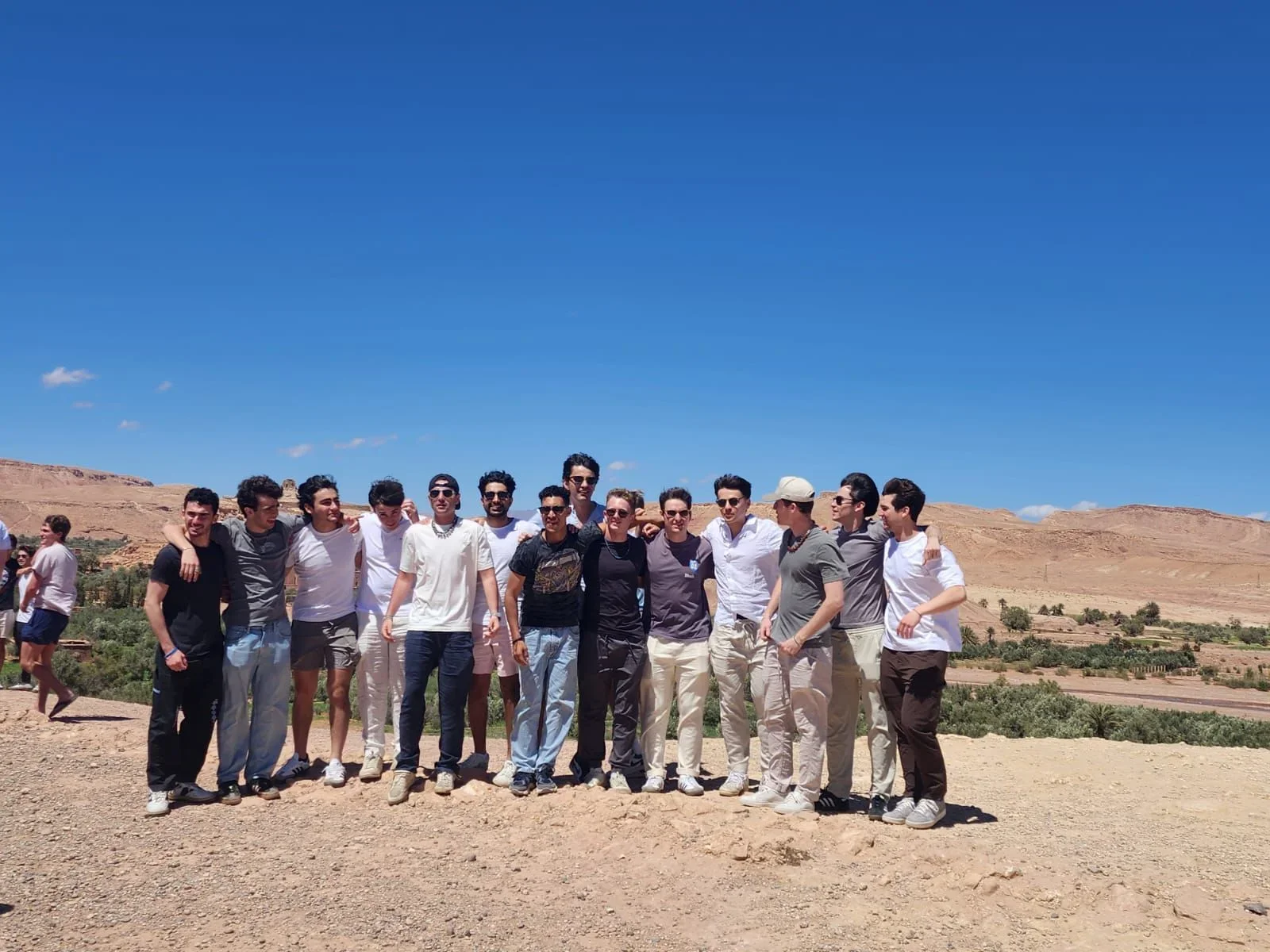Student group exploring Morocco on an educational tour in the Sahara Desert with a local guide
