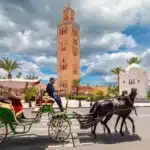 American travelers enjoying a private Morocco tour in the Sahara Desert with camel trekking and luxury camp experience