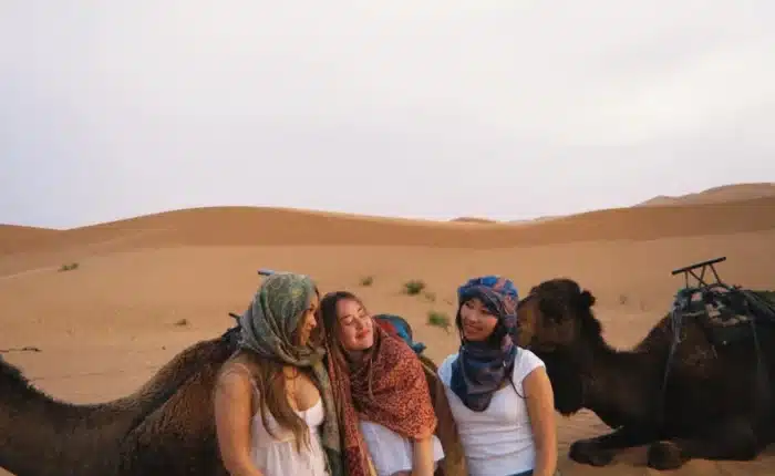Students enjoying quad biking and sandboarding, camel ride activities in the Erg Chebbi dunes, Merzouga.