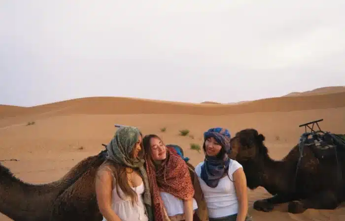Students enjoying quad biking and sandboarding, camel ride activities in the Erg Chebbi dunes, Merzouga.