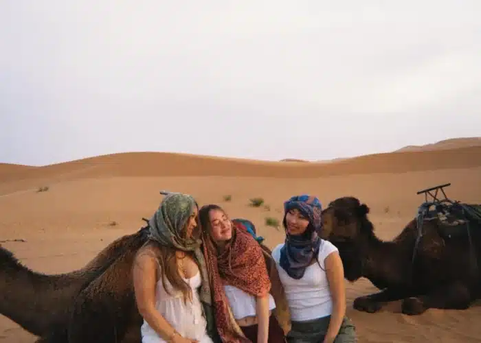 Students enjoying quad biking and sandboarding, camel ride activities in the Erg Chebbi dunes, Merzouga.